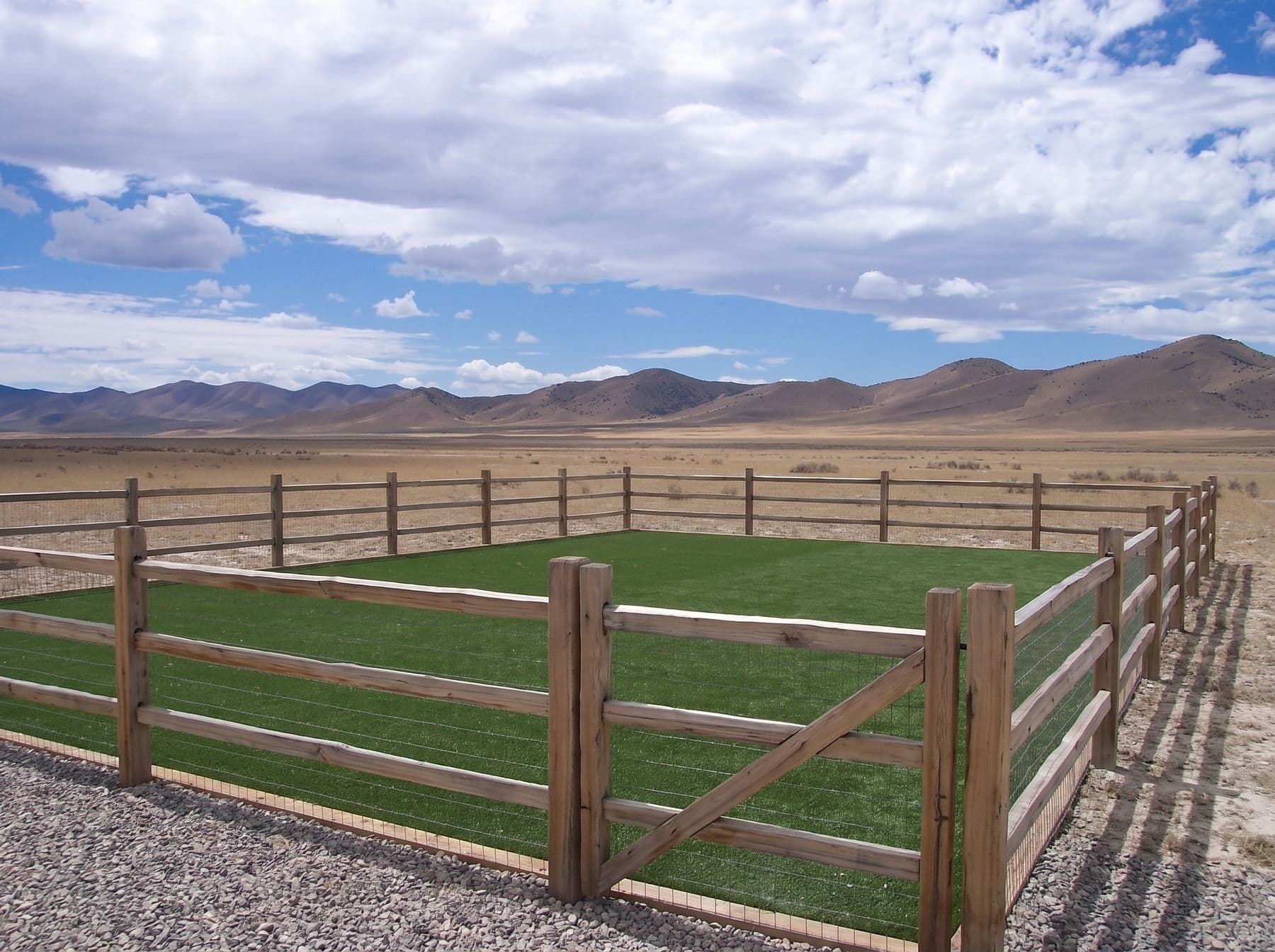Finished artificial turf and hardscape work photographed in a Utah setting