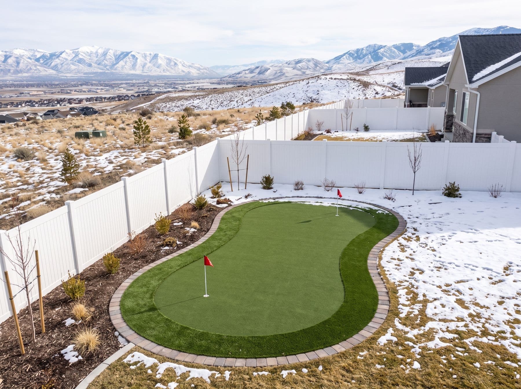 Finished artificial turf and hardscape work photographed in a Utah setting