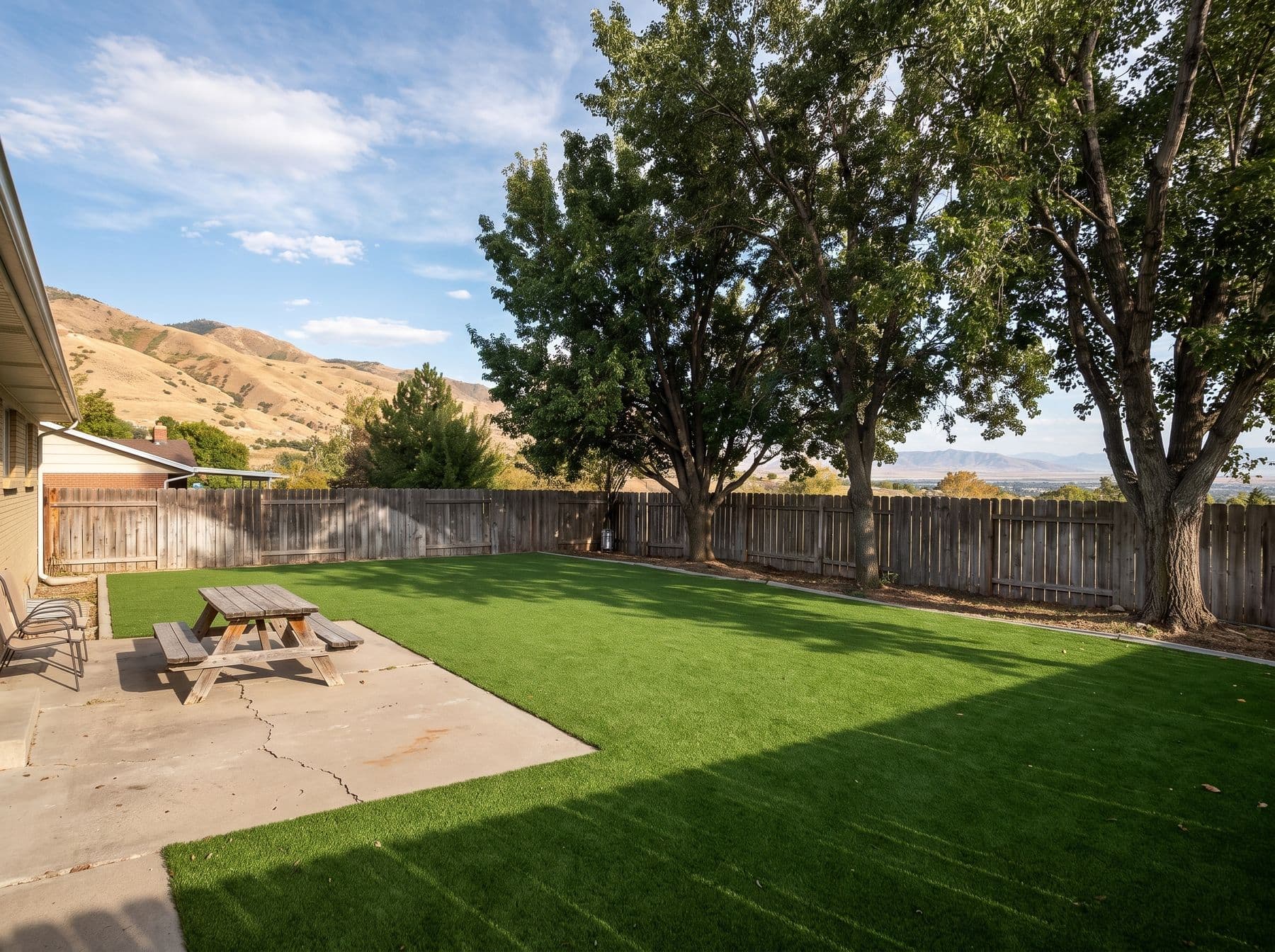 Finished artificial turf and hardscape work photographed in a Utah setting