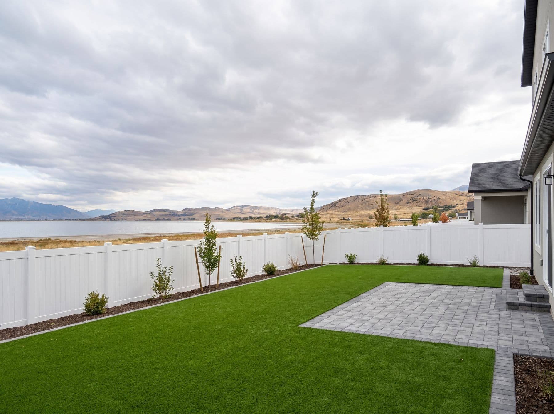Finished artificial turf and hardscape work photographed in a Utah setting