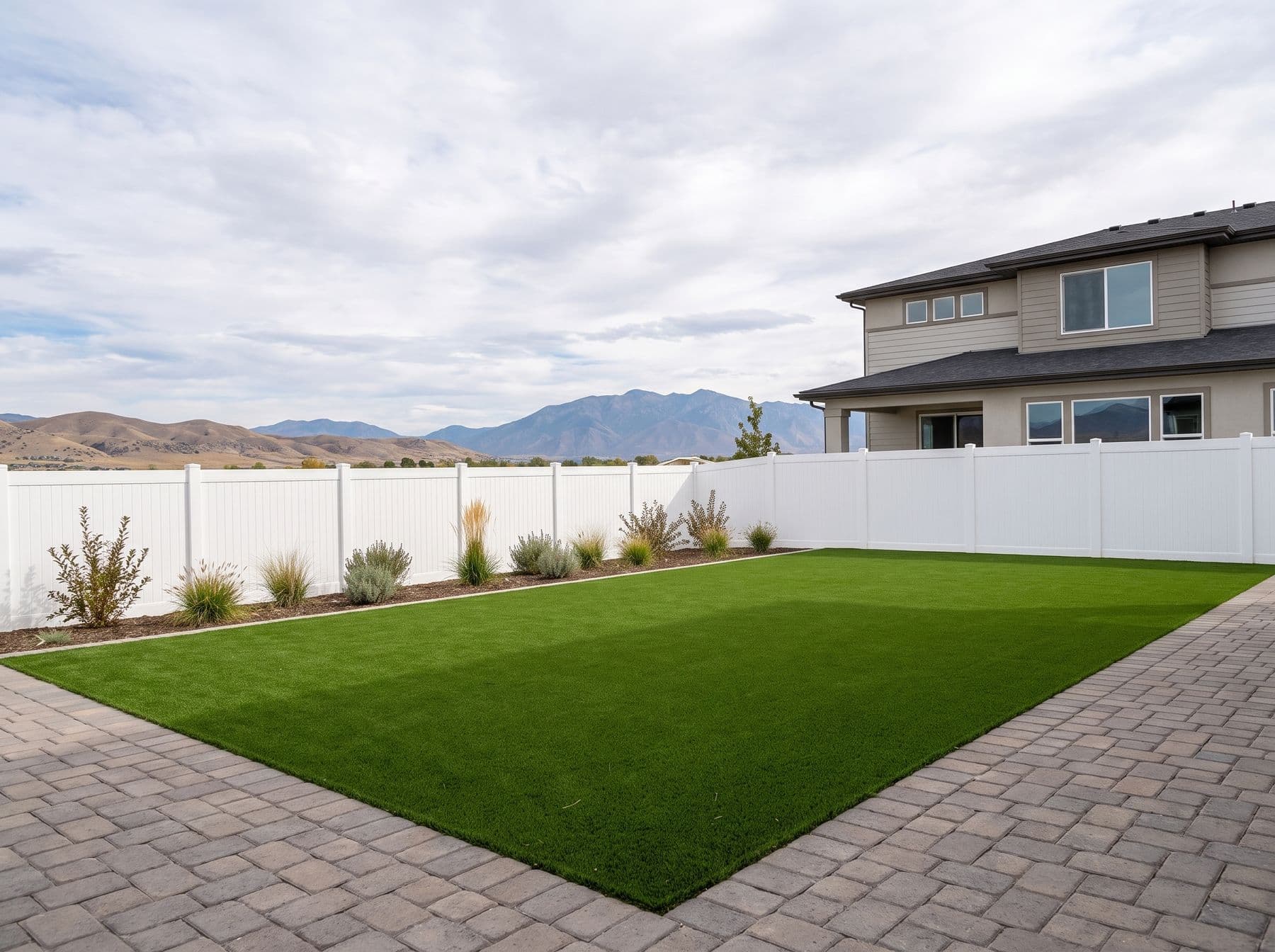 Finished artificial turf and hardscape work photographed in a Utah setting