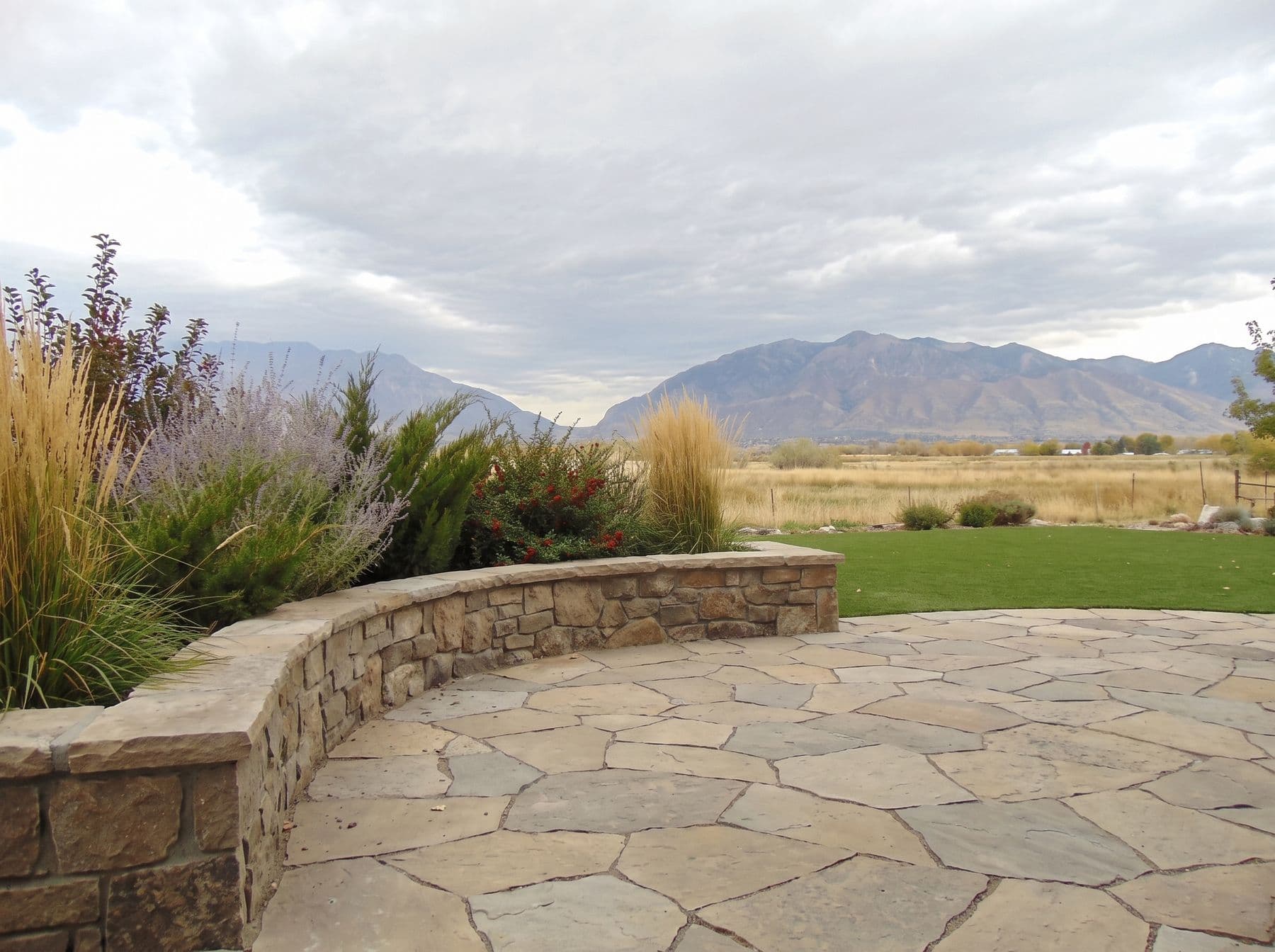 Finished artificial turf and hardscape work photographed in a Utah setting