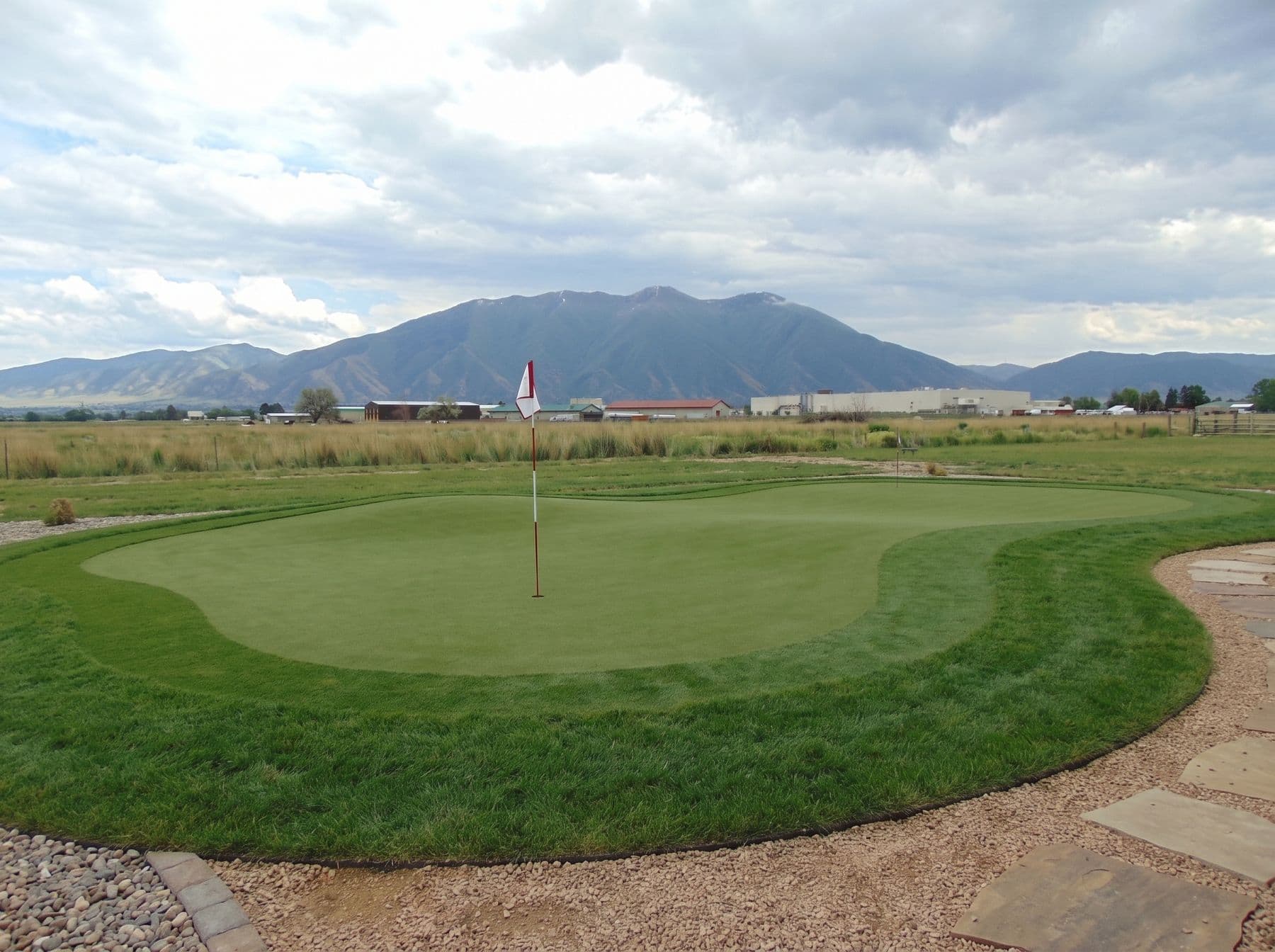 Finished artificial turf and hardscape work photographed in a Utah setting