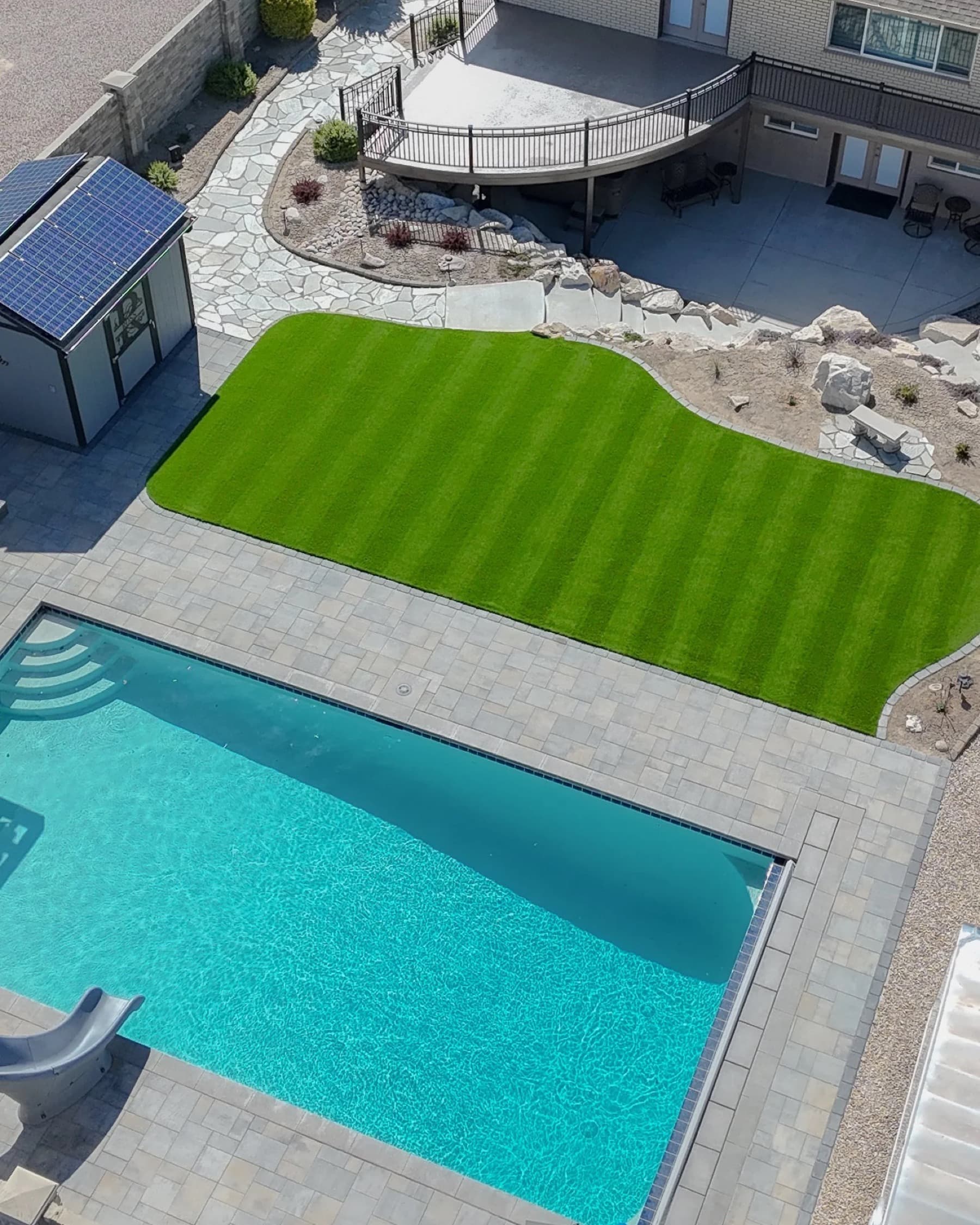 Artificial turf installed around a pool deck