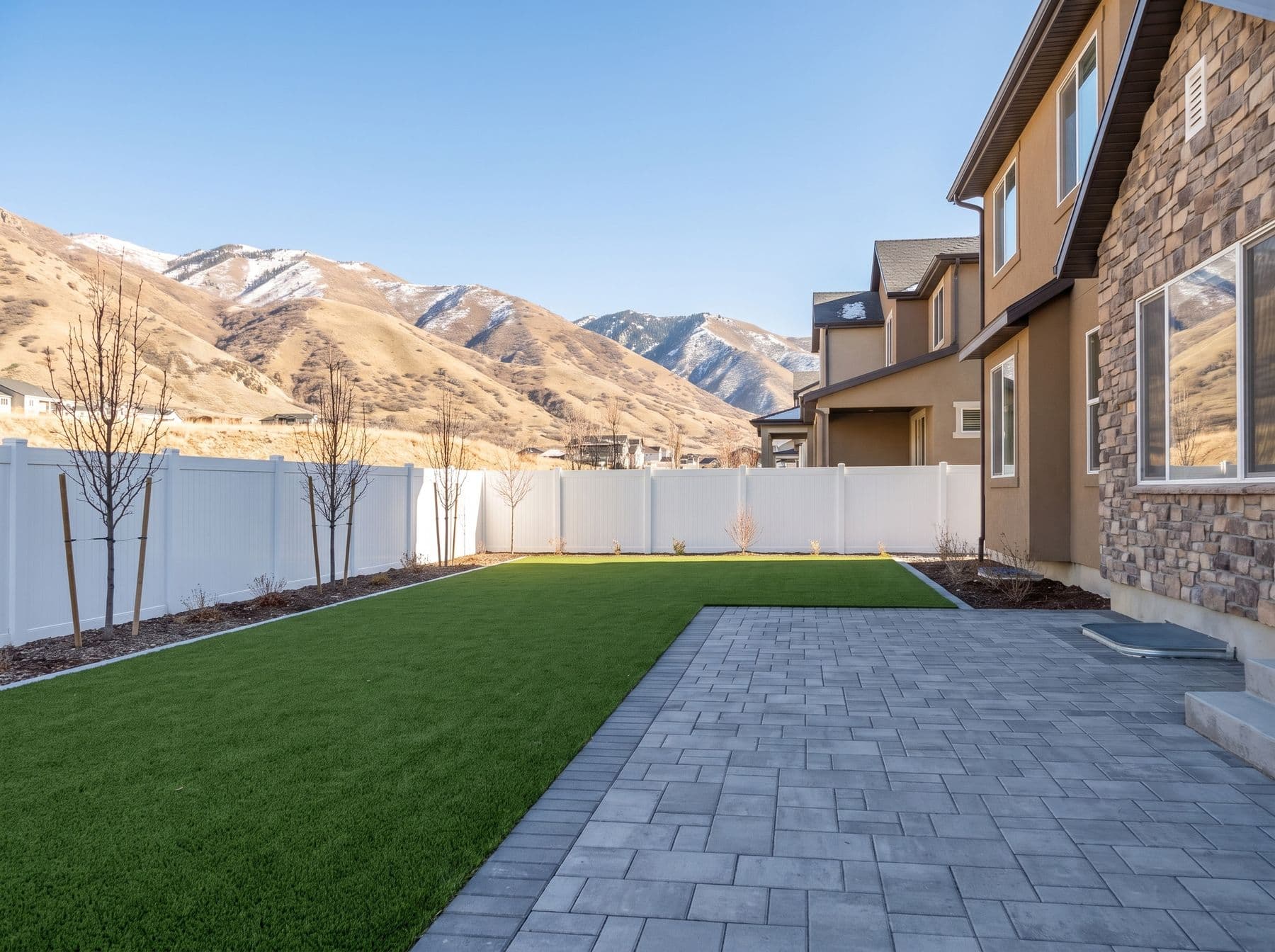 Finished artificial turf and hardscape work photographed in a Utah setting