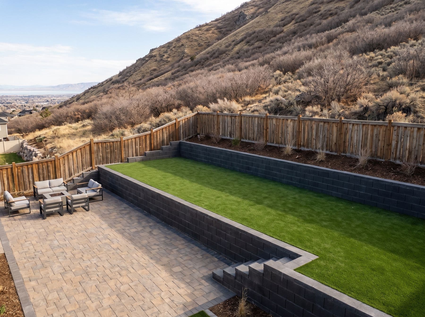 Finished artificial turf and hardscape work photographed in a Utah setting
