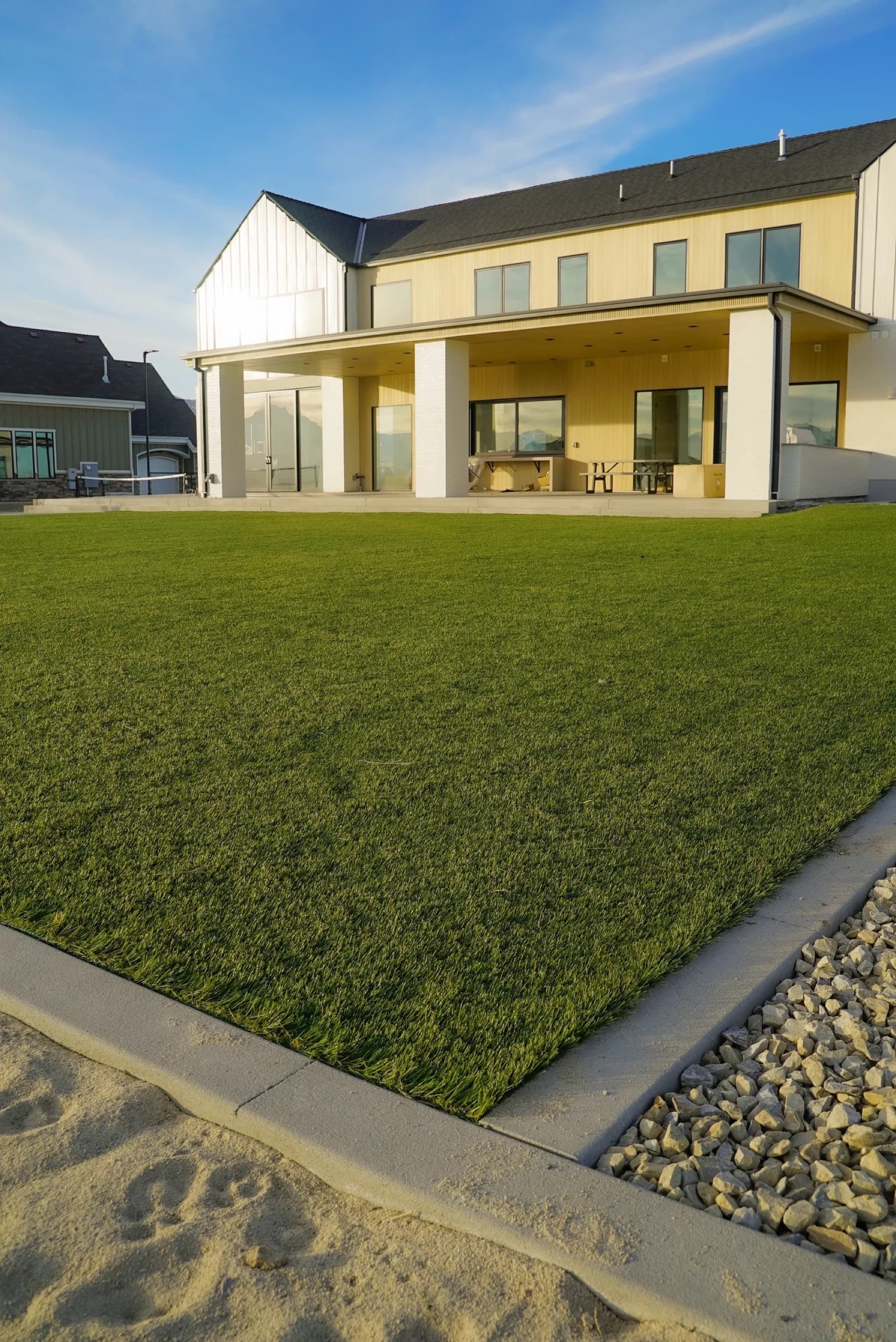 Close detail of artificial turf blades showing pile height and the green and tan fiber blend